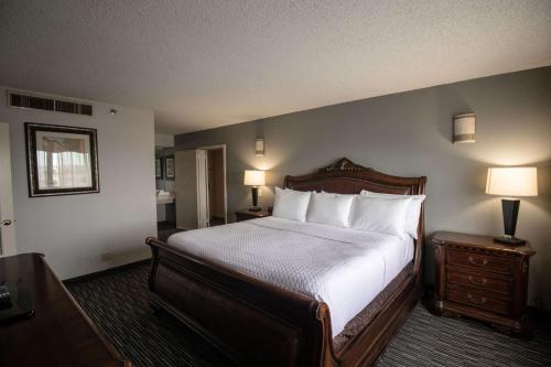 a bedroom with a large bed with white sheets and pillows at Wyndham Houston near NRG Park - Medical Center in Houston