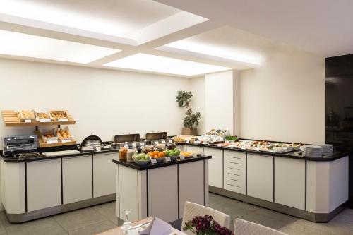 a kitchen with several counters with food on them at Blanca Hotel in Izmir