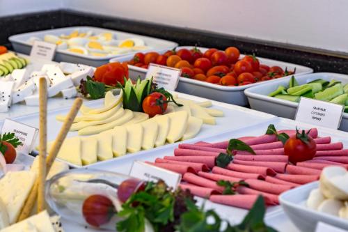 a display of different types of cheese and vegetables at Blanca Hotel in Izmir