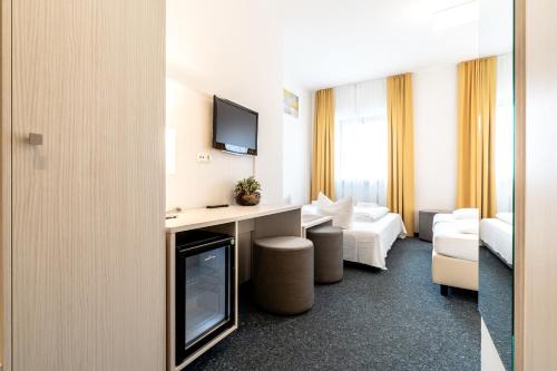 TV a/nebo společenská místnost v ubytování Hotel Wandinger Hof by Lehmann Hotels