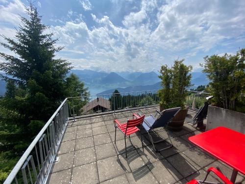 a patio with a table and chairs on a balcony at Hotel Bergsonne Rigi in Rigi Kaltbad