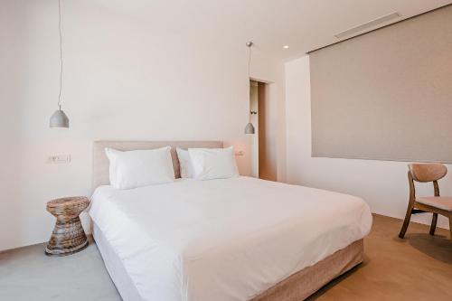 Ένα ή περισσότερα κρεβάτια σε δωμάτιο στο Amarelo Suites