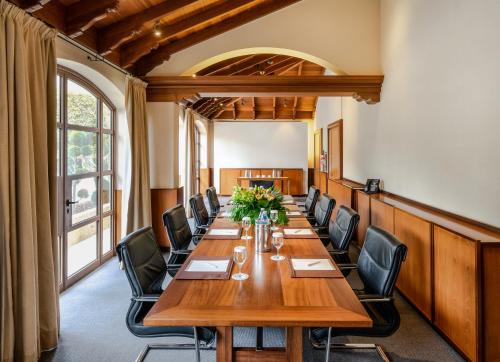 a conference room with a long wooden table and chairs at Columbia Beach Resort in Pissouri