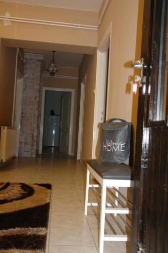 a living room with a table and a bag on a stool at Forest gate Vendégház in Mátraszentimre