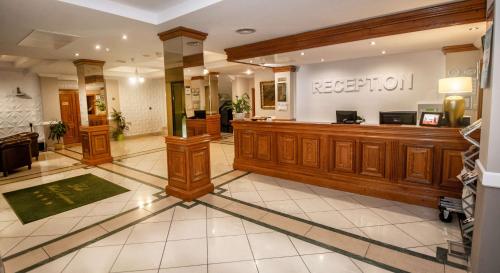 a lobby with a reception desk in a hospital at Best Western Plus Lido Hotel in Timişoara