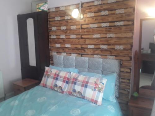 a bedroom with a bed with a wooden headboard at Lincoln House in Bournemouth