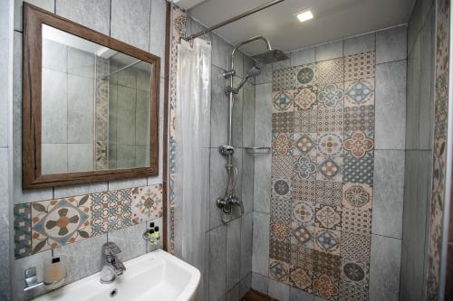 a bathroom with a sink and a mirror at ❁ Casa Frida ❁ Exceptional Stay In Old Town! ❁ in Tbilisi City