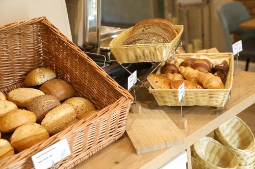 a bakery with baskets of bread and pastries on a counter at Pension Moselvilla 1900 in Cochem