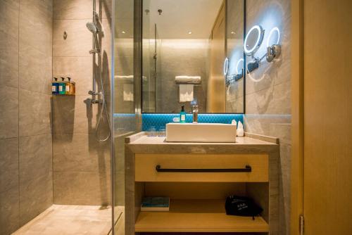 a bathroom with a sink and a shower at Holiday Inn Express Shenzhen Nanshan by IHG in Shenzhen