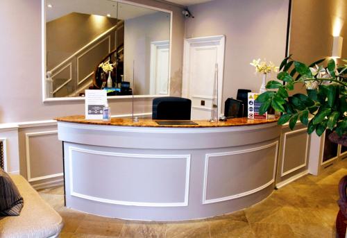 a barber shop with a counter in a room at Rushmore Hotel in London