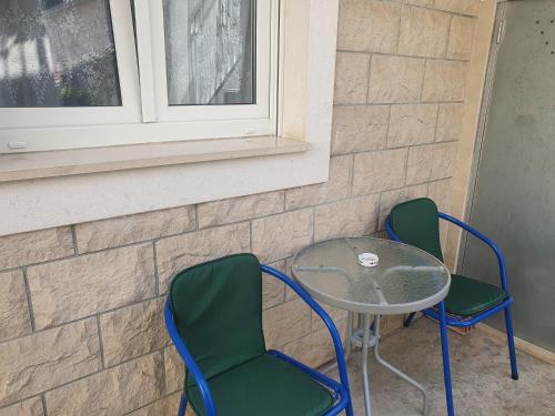 two chairs and a table and a table and chairs at Apartments Duje in Split