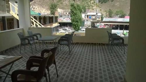 a restaurant with chairs and tables and a view of a building at Hotel Mi-Amore in Naran