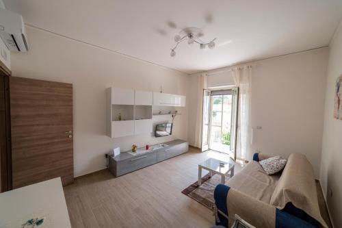 a living room with a couch and a table at Osolemiohouse in Minori