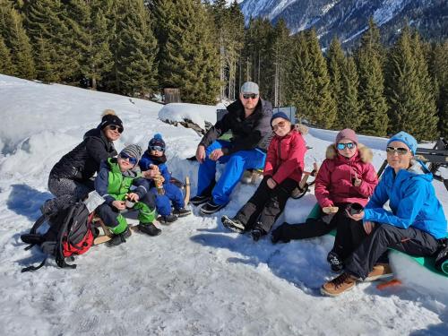 a group of people sitting in the snow at Ferienwohnung Petter in See