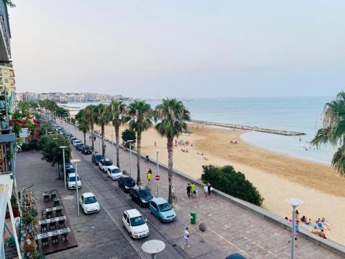 a street with cars parked on the beach at VISTA MARE in Crotone