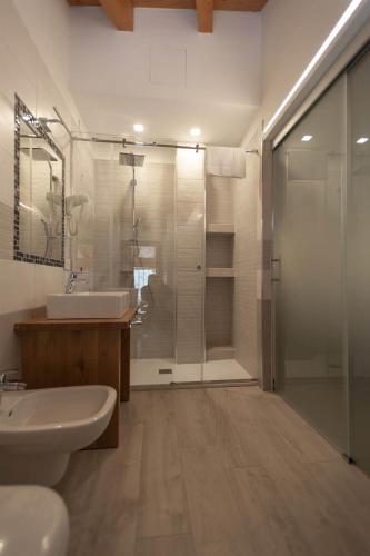 a bathroom with a shower and a sink and a toilet at B&B da Sabry e Gian in Comano Terme