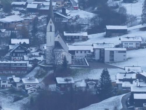 a small village with a church in the snow at Haus Ruepp in Silbertal