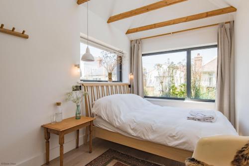 a bedroom with a bed and a window at The Dunes by Bloom Stays in Camber