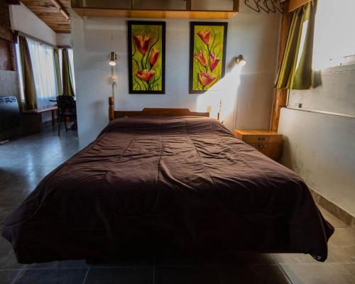 A bed or beds in a room at Cabañas Rosa