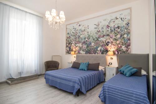 a bedroom with two beds and a large window at B&B 7 Rooms in Pisa