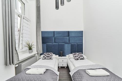A bed or beds in a room at Apartments Wrocław Ruska by Renters