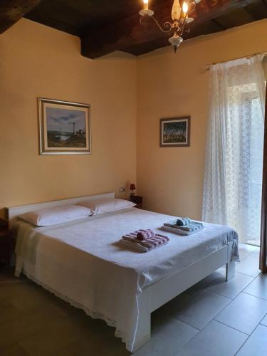 a bedroom with a large bed with towels on it at Il Casolare del Medio Olona in Fagnano Olona