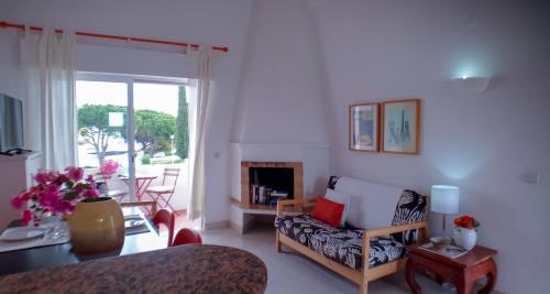 a living room with a couch and a fireplace at Typical TM Flat with a Terrace and Sea View in VSR in Porches
