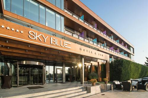 a large building with a sky blue sign on it at Sky Blue Hotel & Spa in Ploieşti