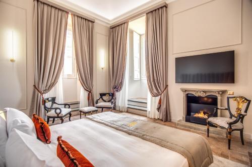 
a hotel room with a large bed and a fireplace at Eitch Borromini Palazzo Pamphilj in Rome
