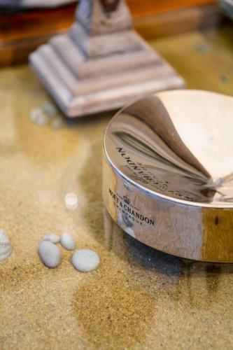 a tin with a book on top of a table at Serenity Luxury Villa, Skiathos in Agia Paraskevi