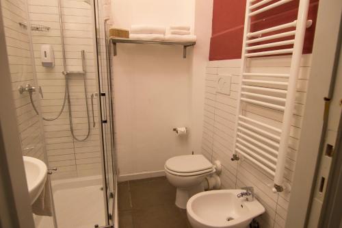 a small bathroom with a toilet and a sink at B&B 7 Rooms in Pisa