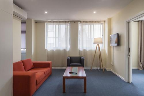 a living room with a couch and a table at Hotel Sete Cidades in Ponta Delgada