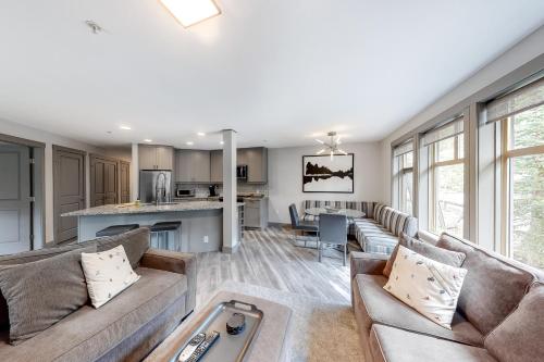 a living room with a couch and a table at Eagle Springs East 206: White Fir Suite in Solitude