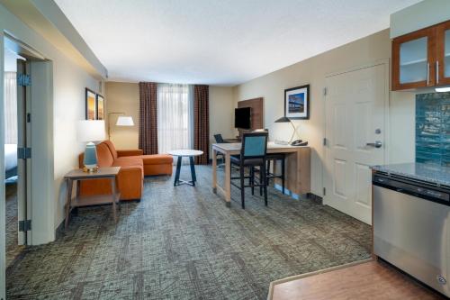 a hotel room with a kitchen and a living room at Staybridge Suites Memphis-Poplar Ave East by IHG in Memphis