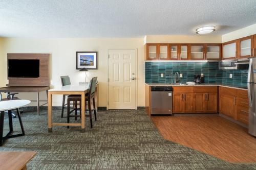 a kitchen with a table and a dining room at Staybridge Suites Memphis-Poplar Ave East by IHG in Memphis