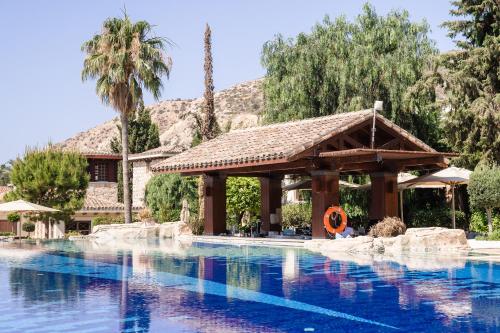 a pool at a resort with a gazebo at Columbia Beach Resort in Pissouri