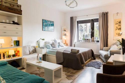 a living room with a bed and a couch at Beautiful Cozy 1-Room apartment, near Rhine in Düsseldorf