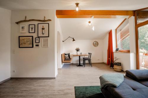 a living room with a couch and a table at Der Lärchenhof Ferienwohnungen in Schönau am Königssee