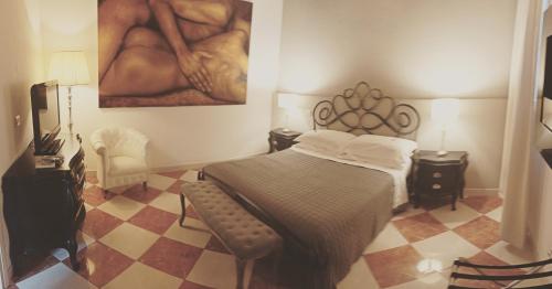 a bedroom with a bed and a painting on the wall at La Corte Dei Sogni B&B in Modena