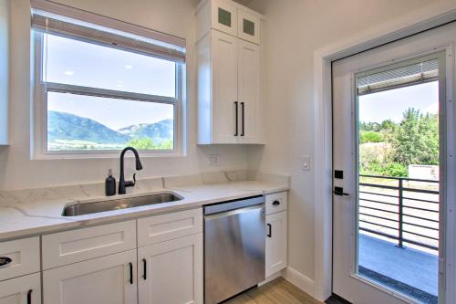 a kitchen with white cabinets and a sink and a window at Modern Mtn View Townhome Less Than 5 Mi to Skiing! in Eden
