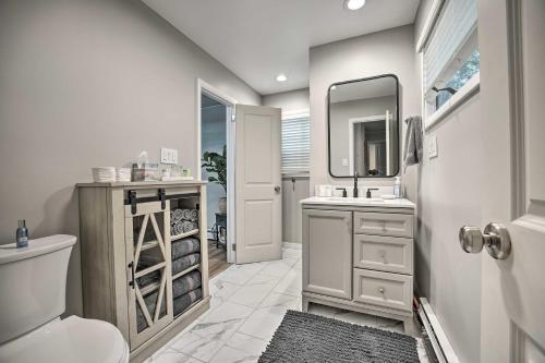 a bathroom with a toilet and a sink and a mirror at Stylish Warsaw Home with Fire Pit and Lake Access in Warsaw