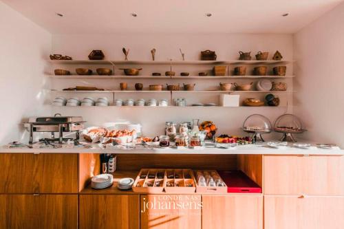 a kitchen with a counter with food on it at Sobreiras Alentejo Country Hotel - by Unlock Hotels in Santa Margarida da Serra