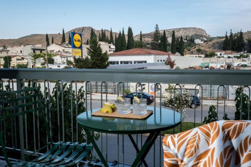 a table with a tray of food on a balcony at apt.27-103 in Nafplio
