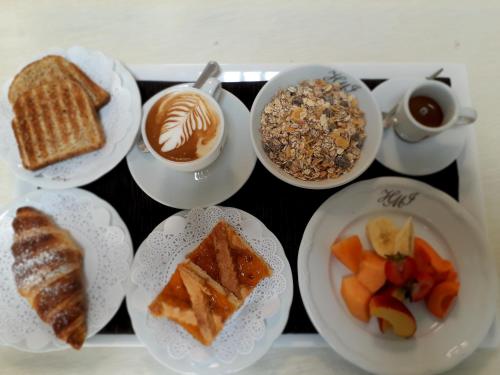 a tray with plates of food and cups of coffee at Hotel Mirasole International in Gaeta