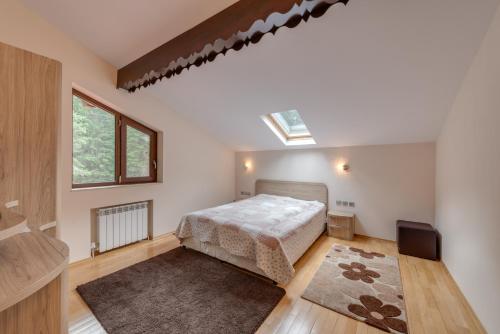a bedroom with a bed and a skylight at Комплекс Орлово гнездо in Beli Iskar