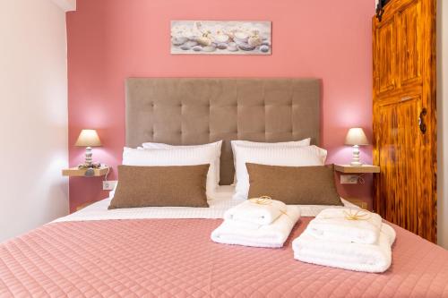 a bedroom with a bed with two towels on it at Naria Medieval House in Rhodes Town