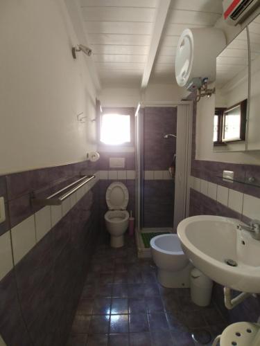 a bathroom with a toilet and a sink at Asso Di Coppa in Scafati