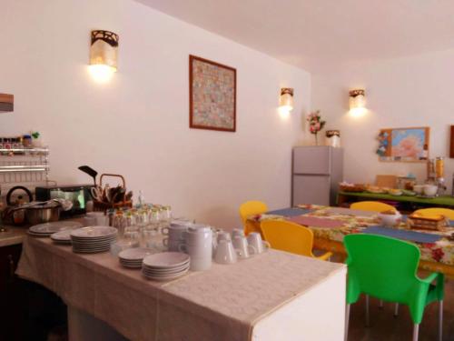 a kitchen with a table with plates on it at Lu Lisandru in Abbiadori