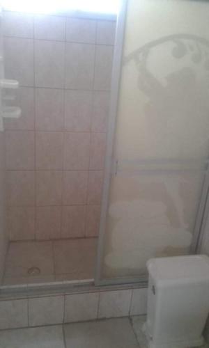 a bathroom with a white toilet and a shower at Casa blanca Atacames in Atacames