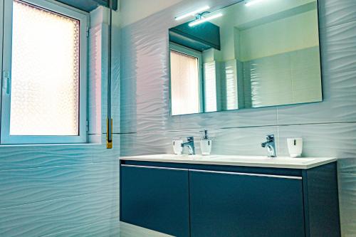 a bathroom with a sink and a mirror at Bed end Breakfast Mediterraneo in Scalea